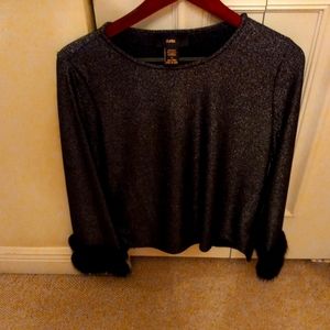 Nice evening wear black blouse with fur on the sleeve the name is rain